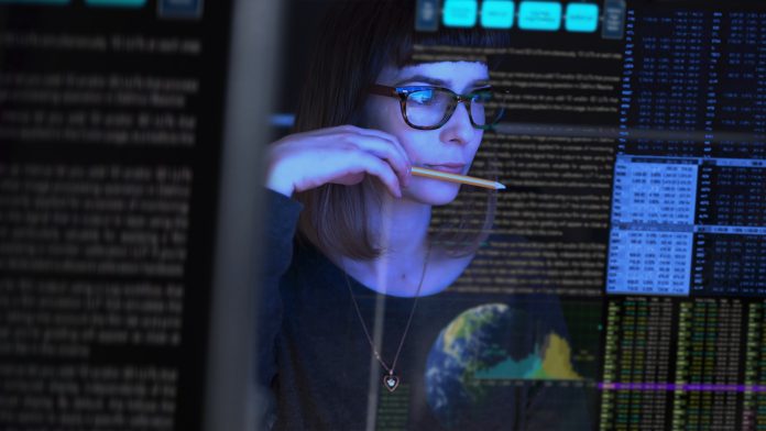 Employee contemplating information on a computer screen